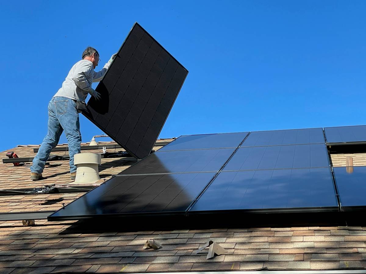 chicago solar panels and green energy installed on a residential rooftop with partial snow cover